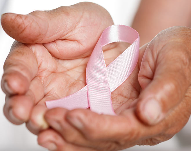 Hands holding breast cancer awareness ribbon