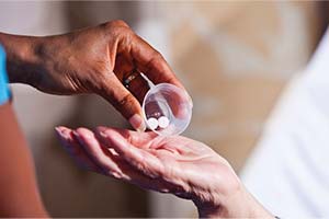 prescription-meds-300x200 Hand pouring pills into another person's open palm